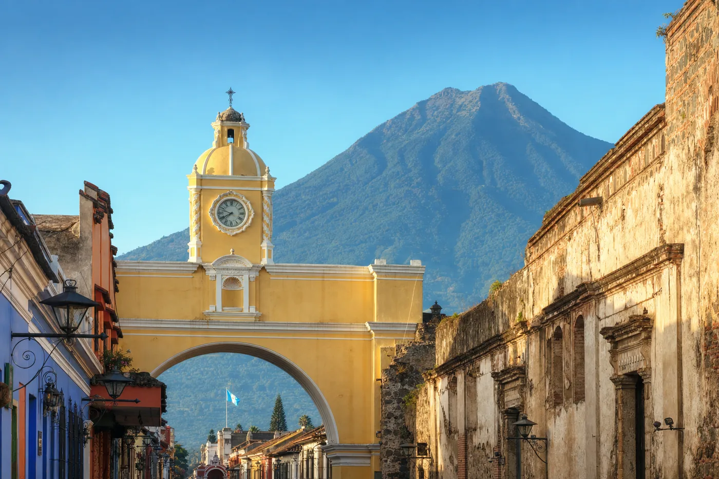 The Santa Catalina Arch in Antigua with a volcano behind it, Guatemala